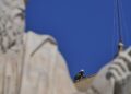 Vatican firefighters set up a chimney on the roof of the Sistine Chapel for the papal election