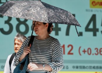 Shares fall and crude costs bounce larger as Trump heads again to US from G7