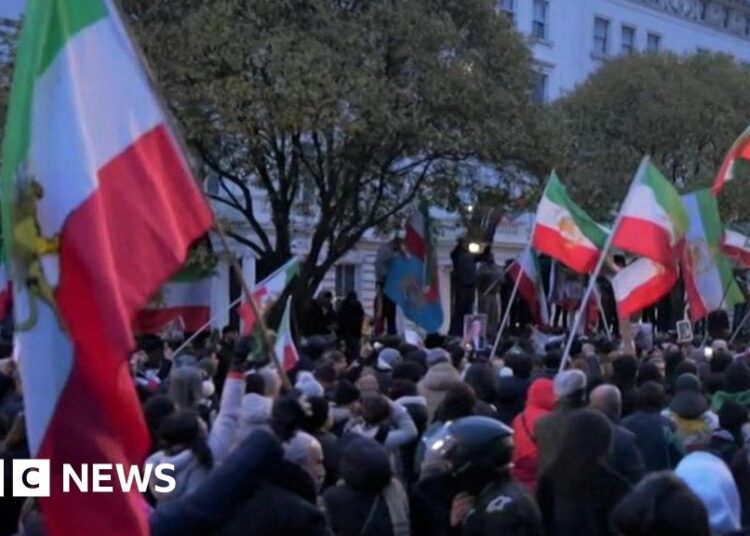 Protester climbs onto balcony of Iranian embassy in London