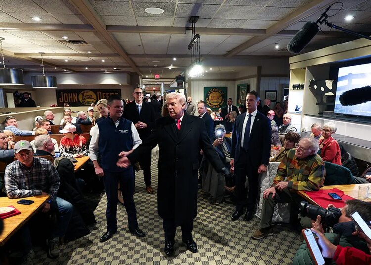 President Donald Trump receives prayer from Iowa restaurant patron