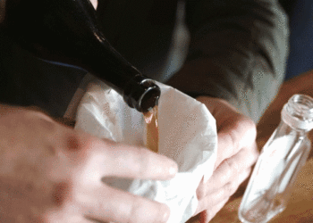 Distillers style the contents of a 150-year-old alcohol bottle present in Utah mining city