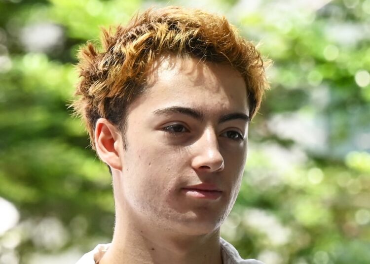 French teen charged in Singapore over a merchandising machine straw-licking video